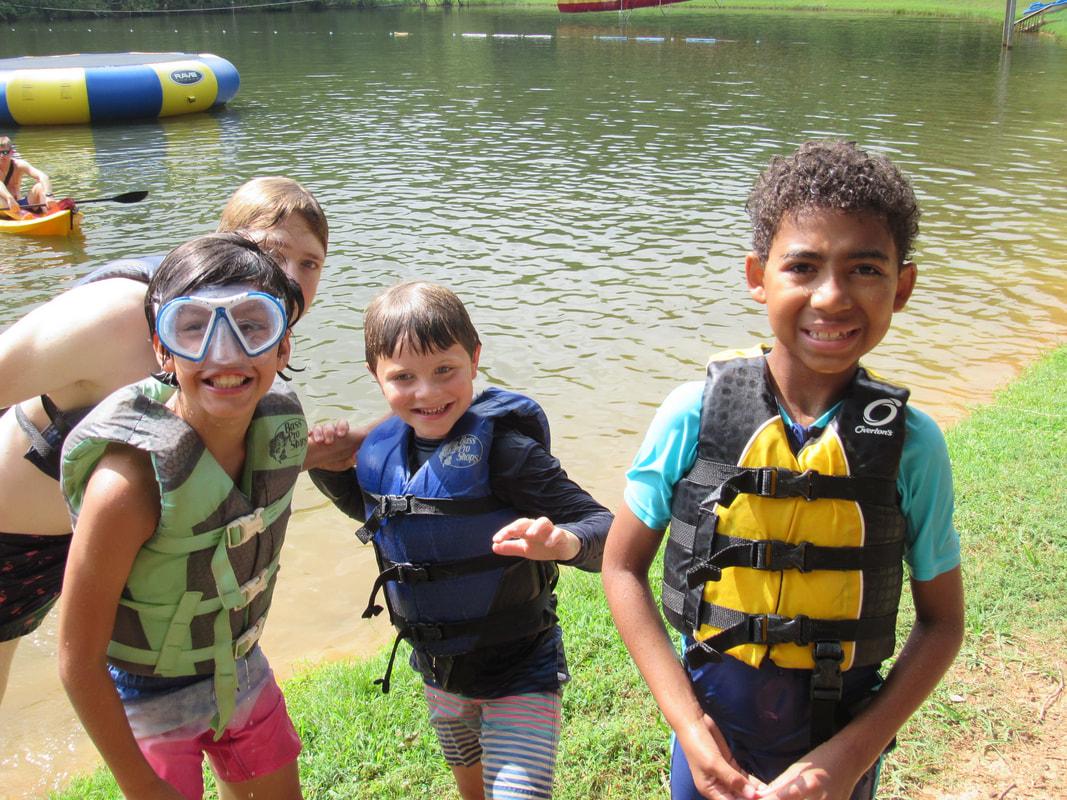 caregiver-info---campers-swimming-at-the-lake image campers boating in the lake.jpg