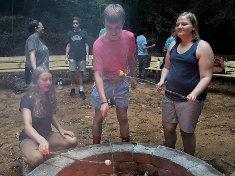 night-owl-group-making-smores image Night Owl Photo 2